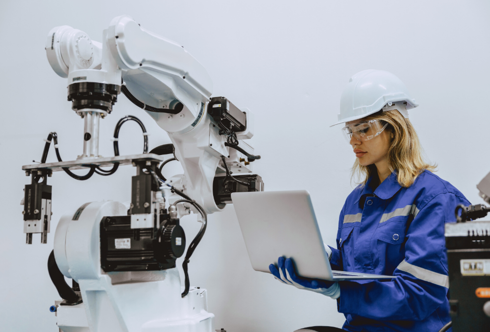 Automated robotic arms assisting human workers in an assembly line to improve production speed and accuracy.